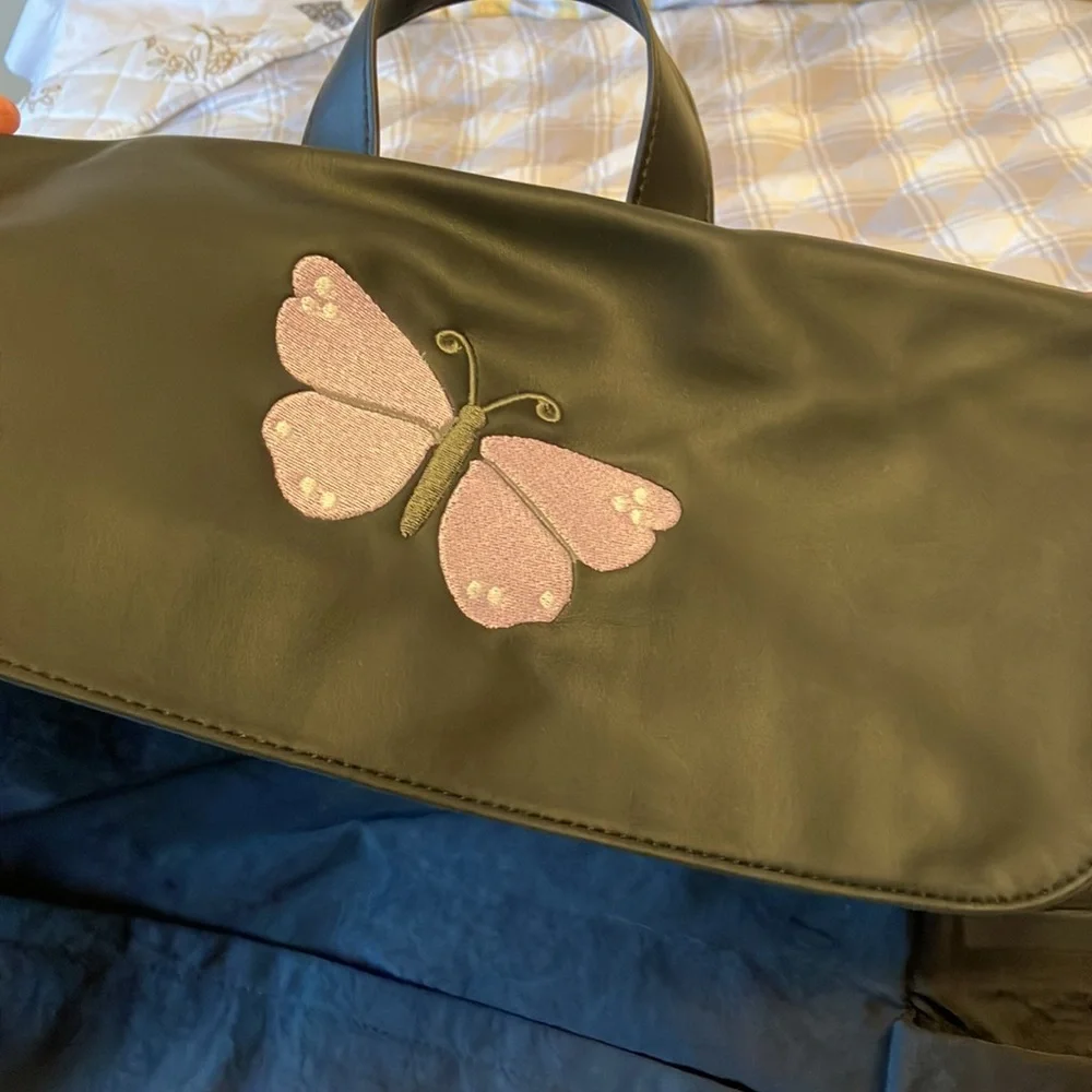 On the go backpack by Thirty-One. New in bag. Butterfly embroidered on flap